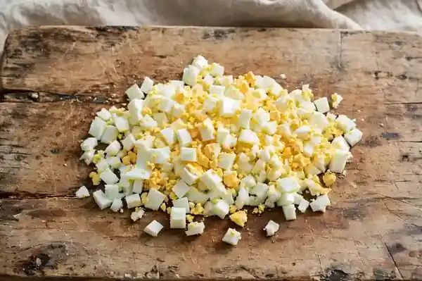 Peeled boiled egg chopped into small bite-sized pieces