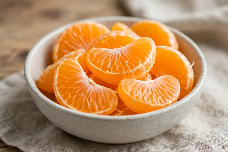 Peeled seedless mandarin segments in a small bowl